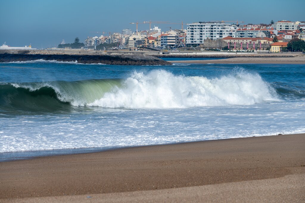 The Douro river empties into the Atlantic, with the beach of Foz do Douro in the background