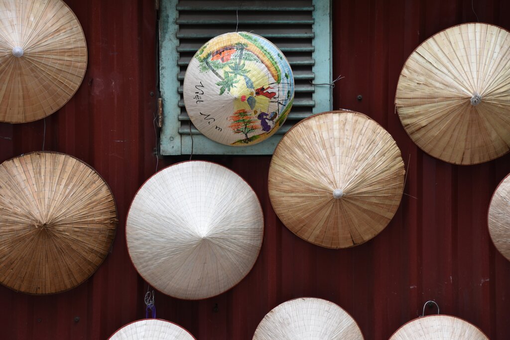Traditional paper hats on a wall in Hanoi