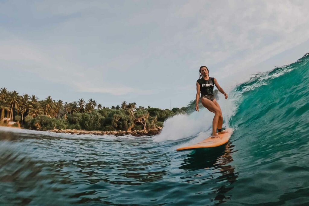 Surfing in the waters of Hiriketiya