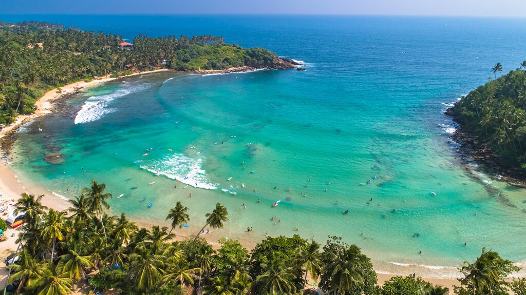 Surfing in the waters of Hiriketiya