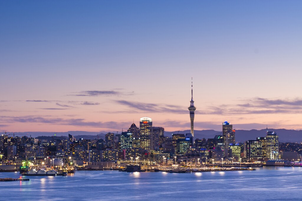 View the skyline from the water after sunset