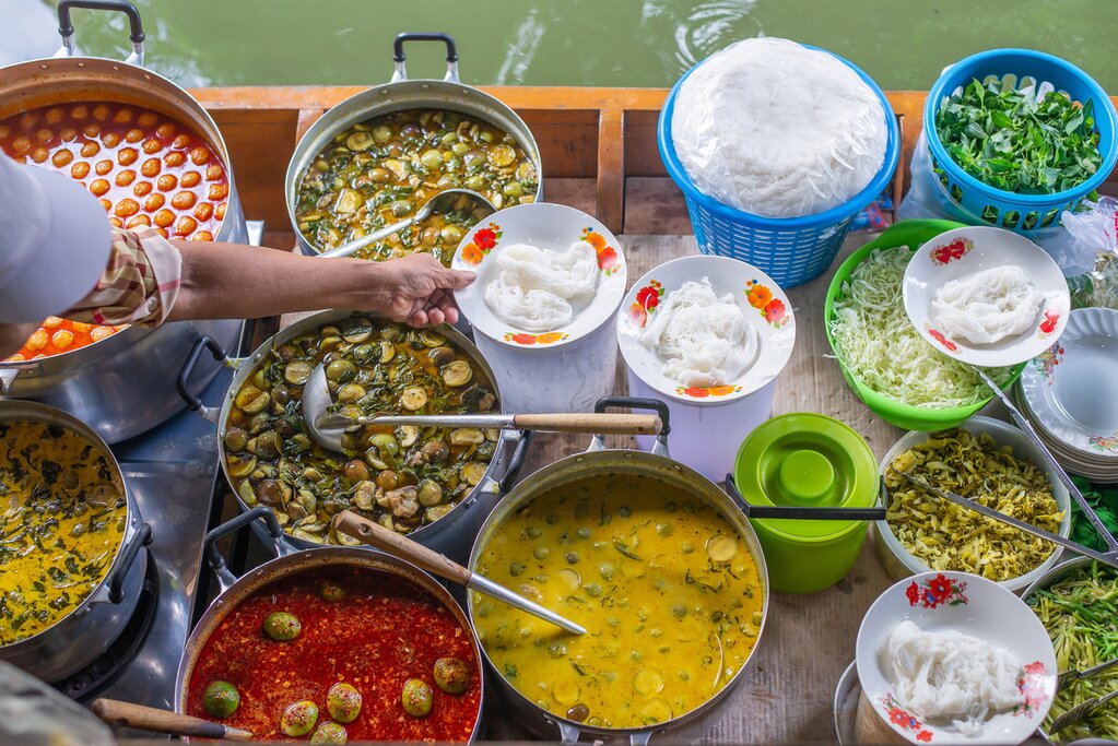 Enjoy lunch on the water at the floating market of Damnoen Saduak