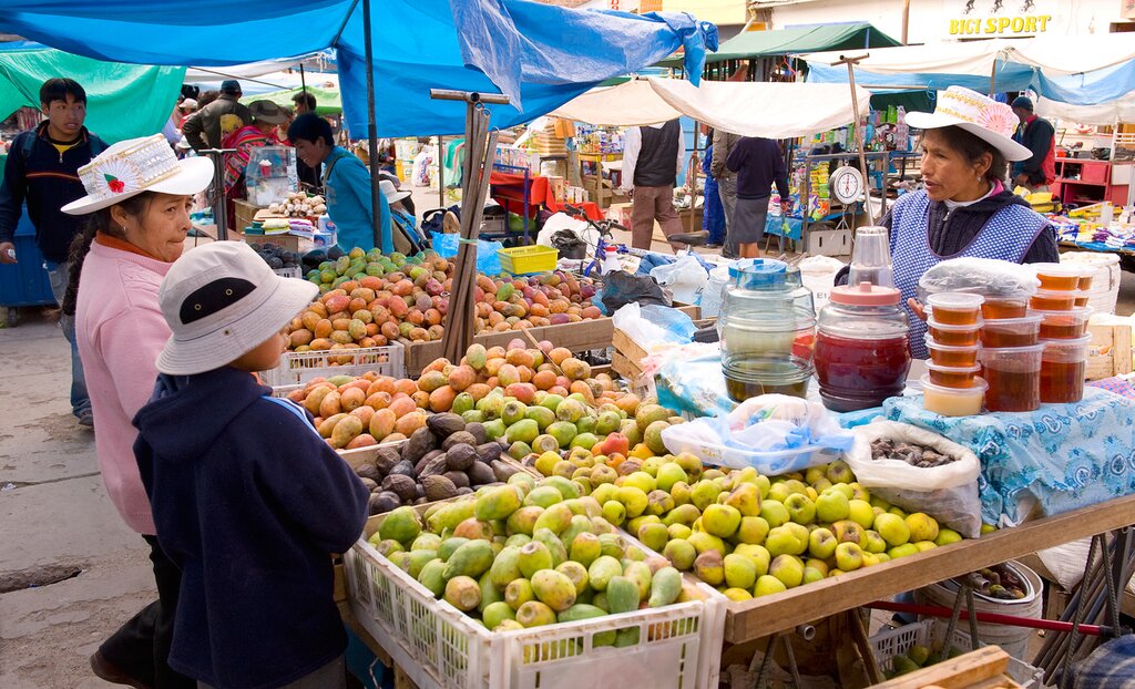 Locals at a fruit and vegetable stall in the central market. - Chivay is a town in the Colca valley at about 3600 mt above sea level.