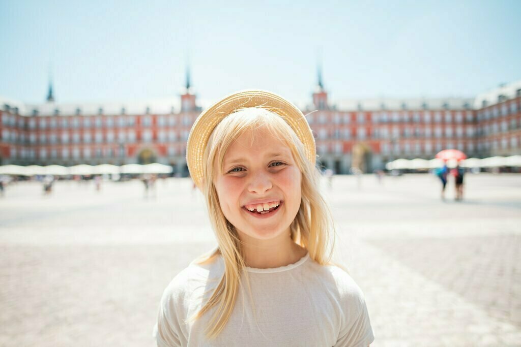 A girl stands in Madrid's Plaza Mayor