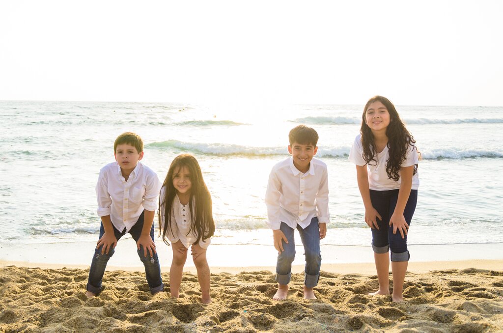 A group of children on the beach by the sea on the Peruvian coast