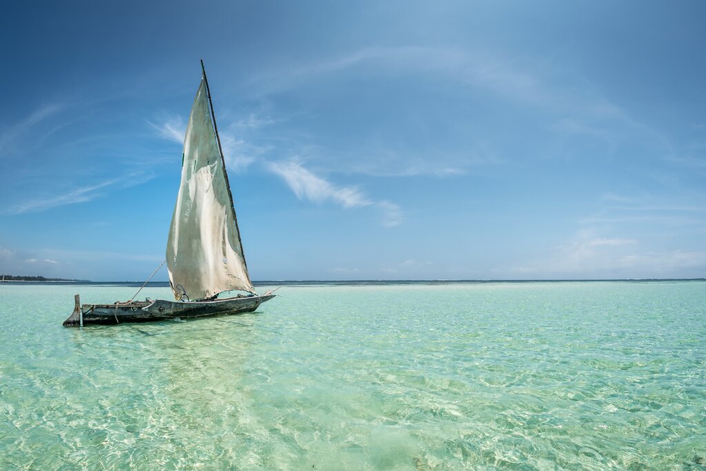 Explore the waters off the Tanzanian island of Lamu from a traditional dhow sailboat