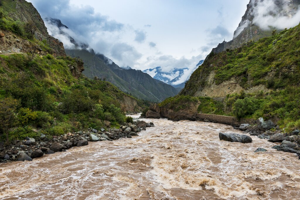 View of Urubamba River looking out from the middle of the river with green slopes on either side