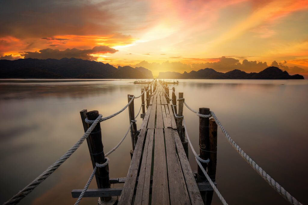 Sunset at the wooden pier in Ao Talet bay, Khanom