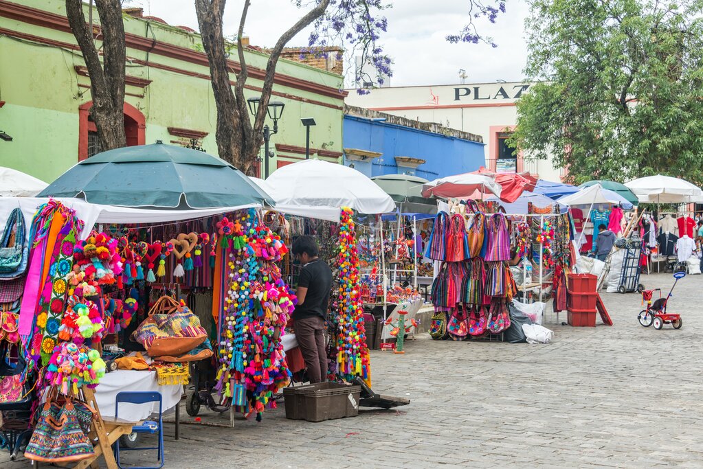 A city street in Oaxaca, Mexico, with booths selling local handicrafts