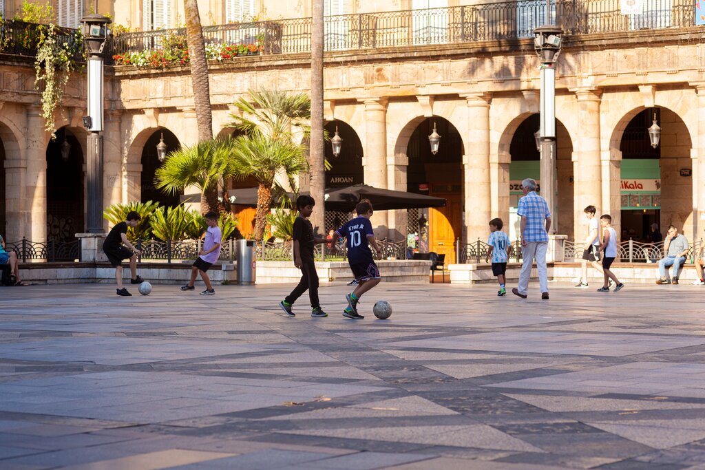 Children play soccer in one of Bilbao's plazas