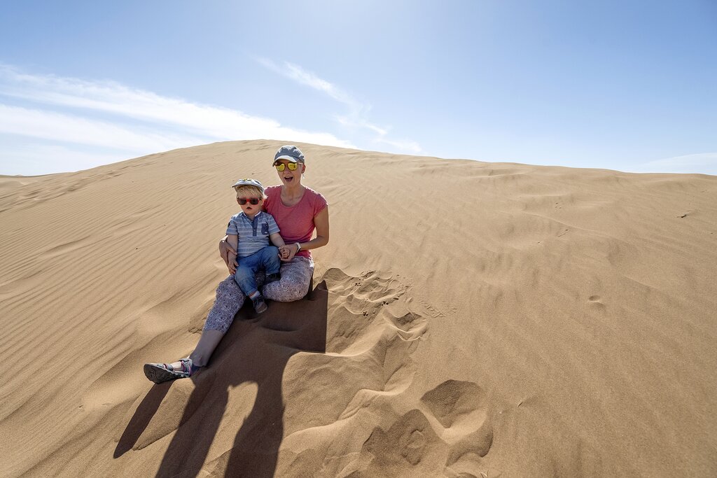 Mother and child on sand dunes