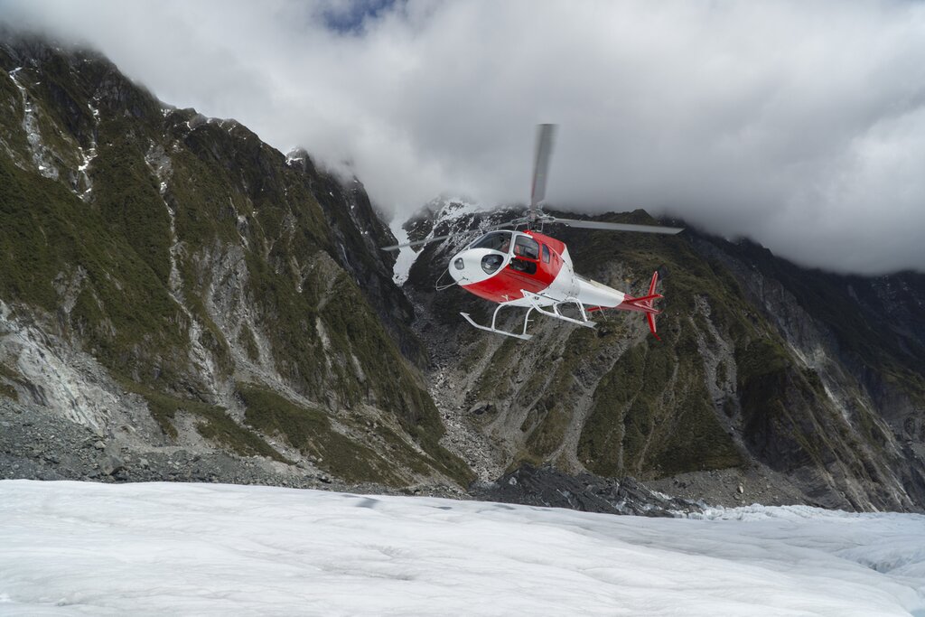 Helicopter landing on Franz Josef Glacier, South Island.