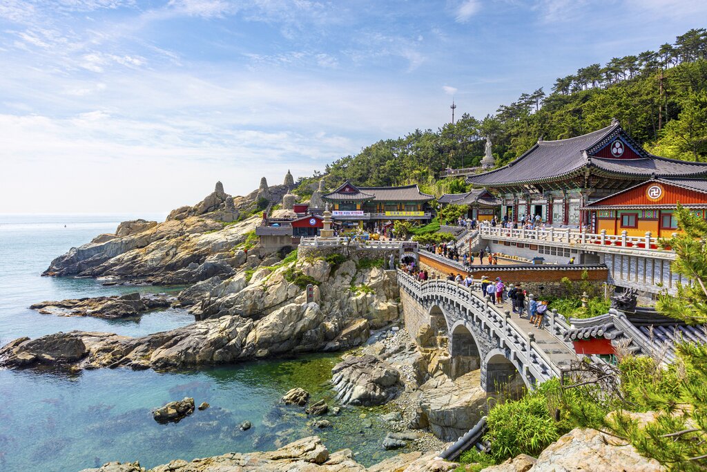 Climb Haedong Yonggungsa Temple's 108 steps lined with stone lanterns in Busan