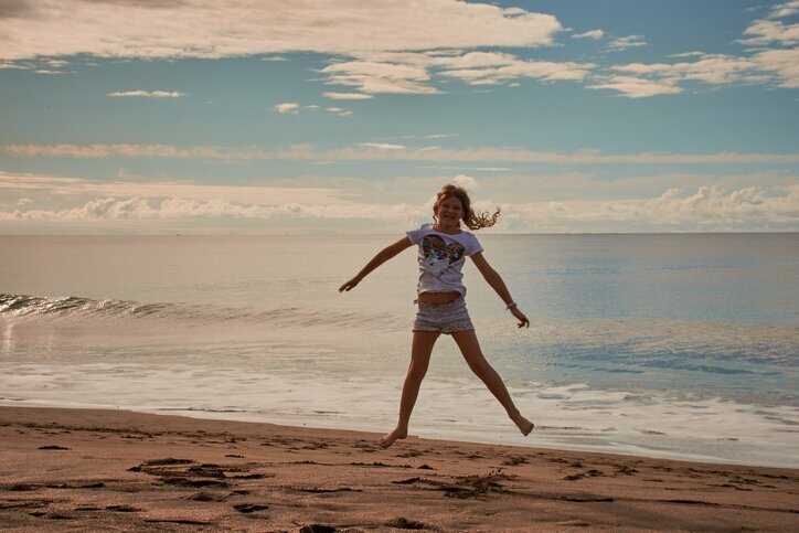 Child playing at the beach in Portugal