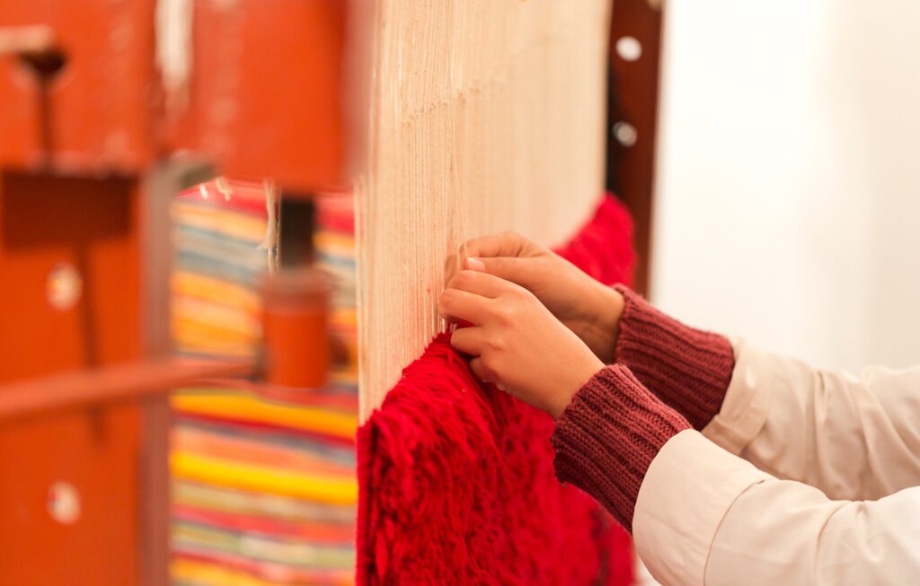 Berber woman weaving a traditional rug
