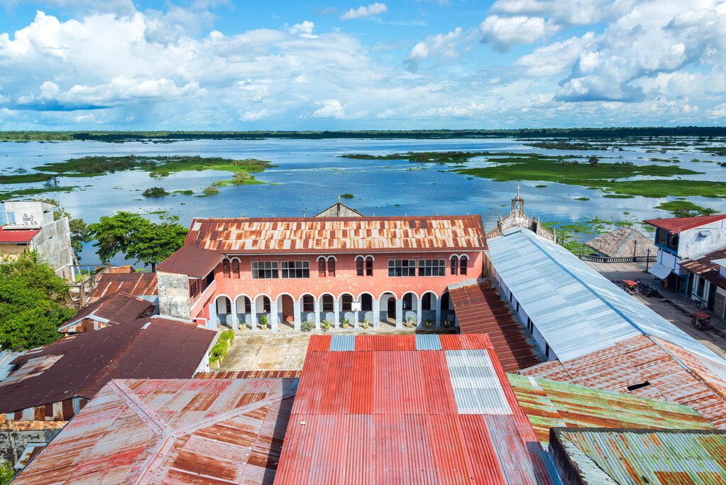 Aerial view of Iquitos, Peru. Tin roofs, a small square, and the Itaya River are visible