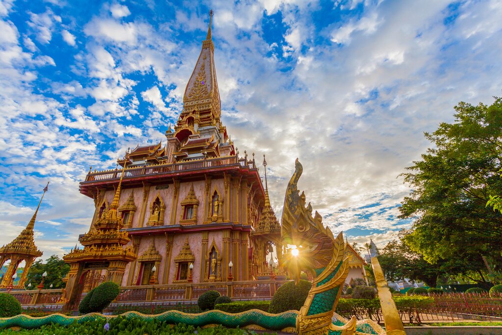 Photo of Wat Chalong on Phuket on a cloudy day with the sun streaming in from the background