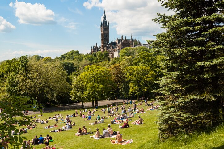 A Scottish summer day in Kelvingrove Park, with Glasgow University at the top of the hill