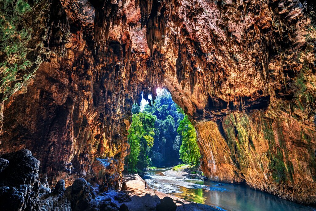 Venture the Tham Lod cave system in northern Thailand by boat or bamboo raft
