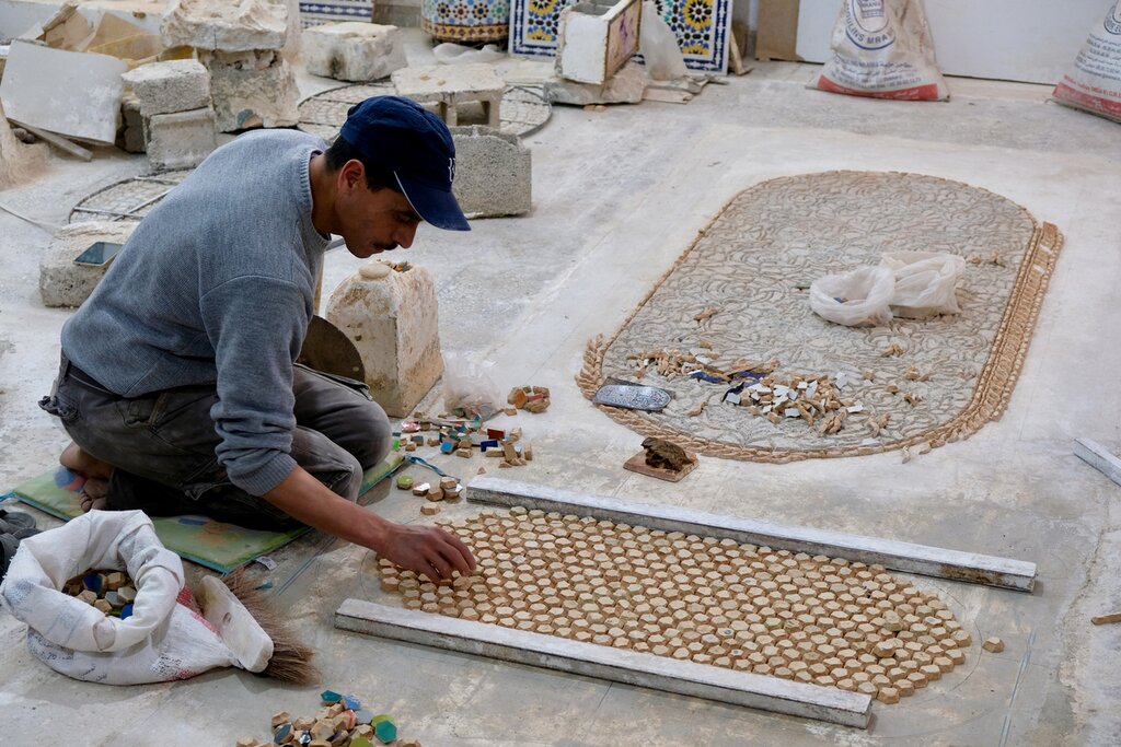 Worker in Fes arranging tiles