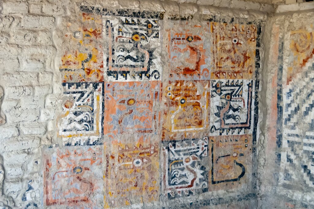 Detail of a mural the El Brujo complex. The mural resembles a patchwork quilt and is composed of black, yellow, red, and white lines
