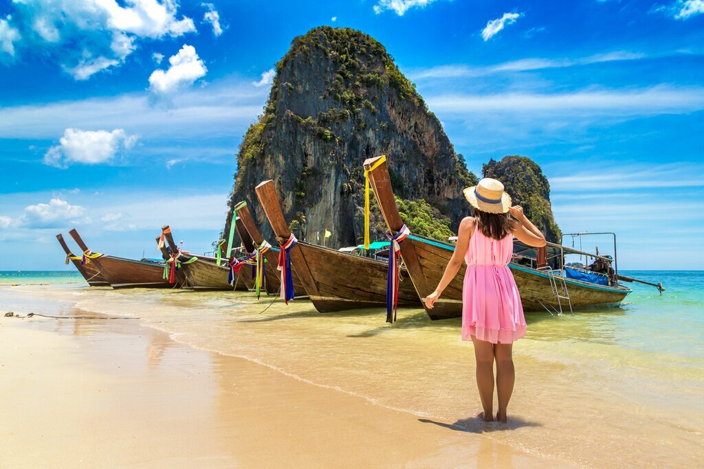 Traditional boat parked on sandy beach in Thailand
