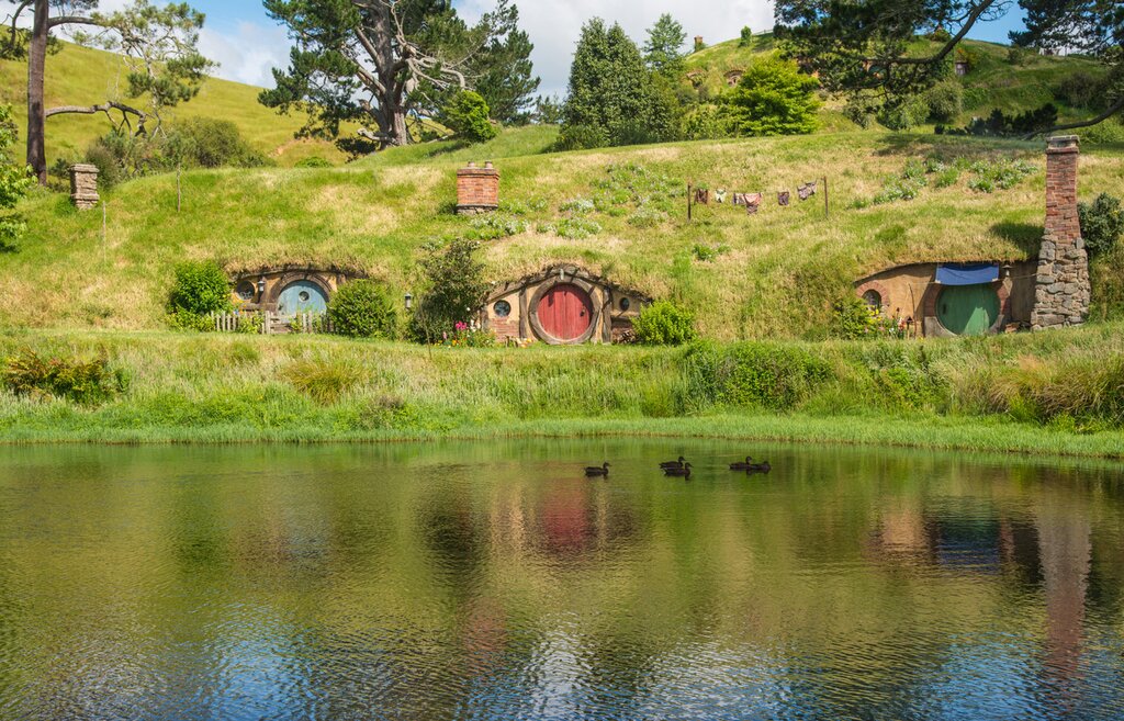Hobbit holes at the waterfront in Hobbiton movie set in Matamata