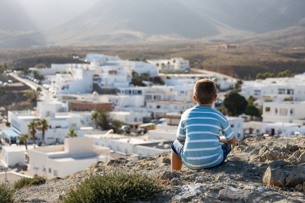 A little boy looks out to the famous white villages in Andalusia