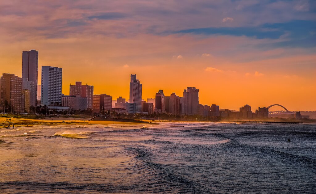 Durban golden mile beach with white sand and skyline KZN South Africa at sunset