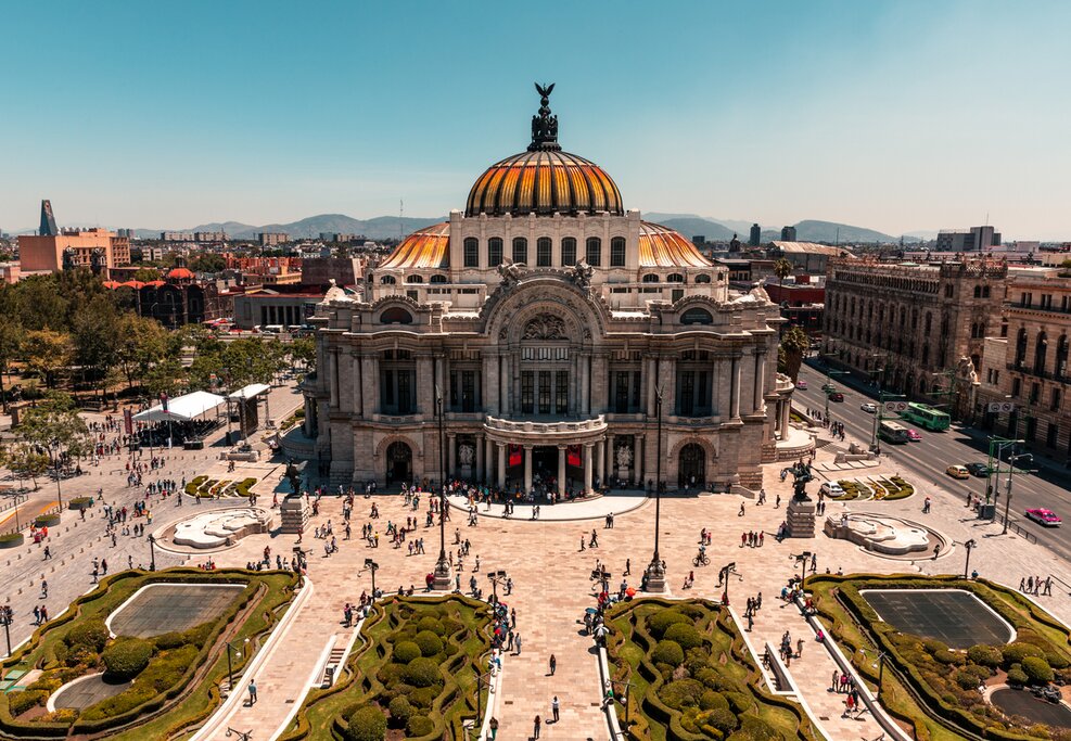 Aerial view of the Palacio de Bellas Artes, Mexico City, during the day with some people walking in the plaza