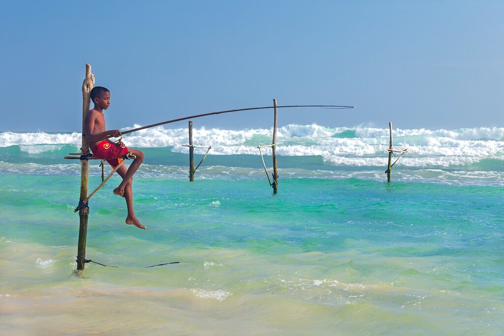 Children practicing traditional fishing skills in Hikkaduwa