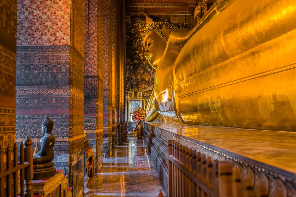 Photo of the golden Reclining Buddha, a huge statue of the Buddha on his side, taken from near the statue's feet