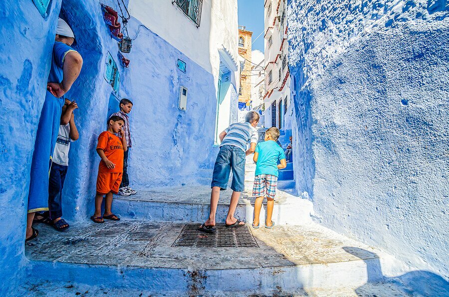Kids exploring Morocco's "Blue City"