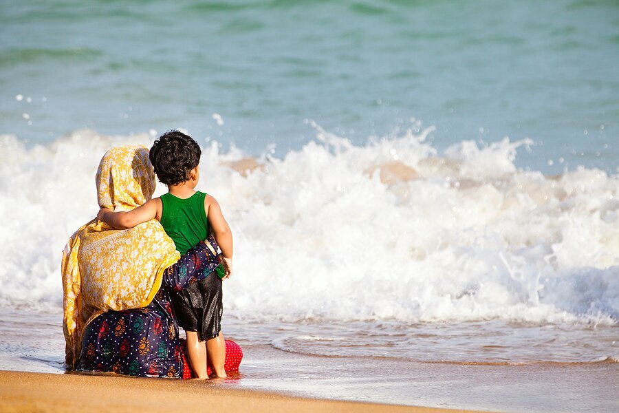 mother and son stare at the ocean