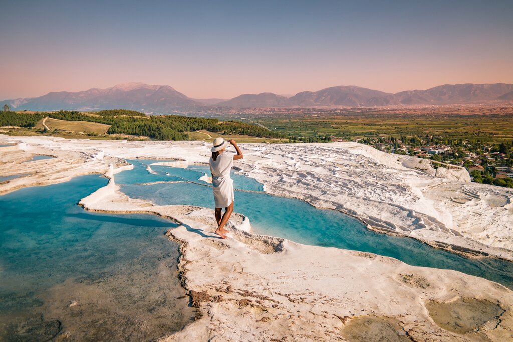 Spend a night in Pamukkale to visit its dramatic terraced hot springs and nearby ancient ruins