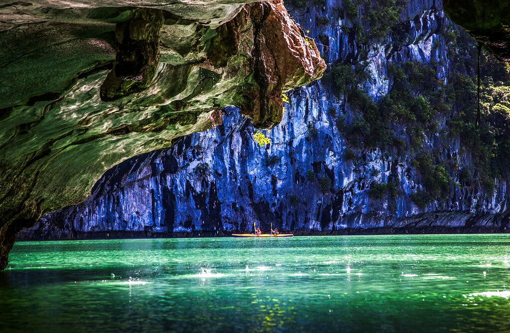 Kayak between hidden caves on a luxury cruise of Ha Long Bay