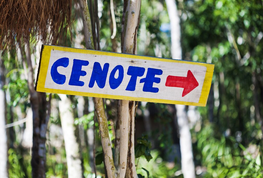 A sign showing the direction of a cenote in the Yucatán Peninsula