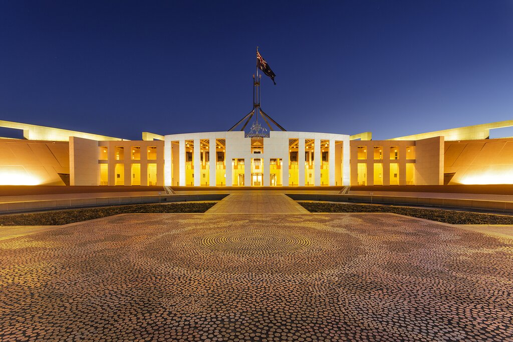 Parliament House in Canberra, surrounded by autumn foliage.
