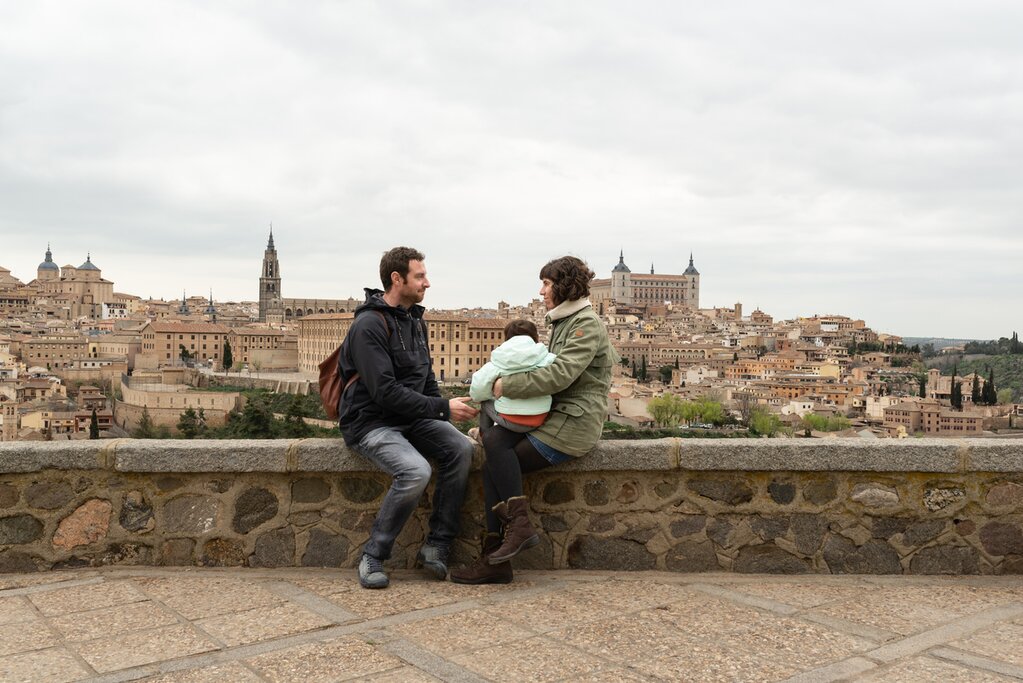 Family poses for a picture with the Toledo skyline in the background
