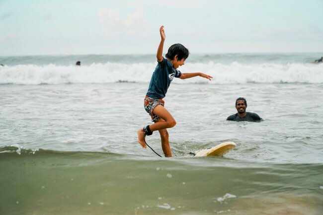 Learn to surf in a safe and secluded area of Weligama Bay
