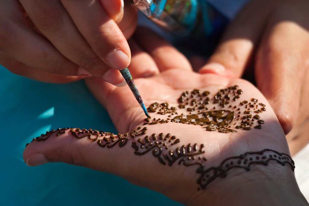 A girl gets a traditional henna tattoo