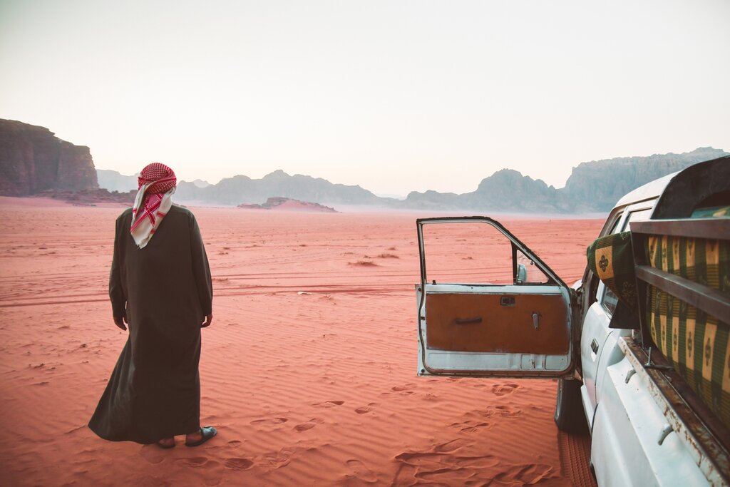 Spend a night in the red deserts of Wadi Rum and explore rock formations and dunes by Jeep