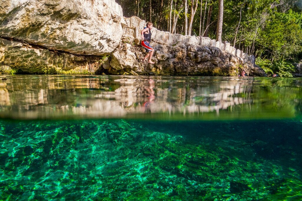 Kid jumping into a cenote