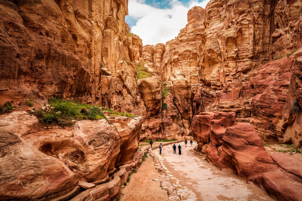 Your five-day trek ends in style as you ender the UNESCO-listed Petra through it's quieter back trail