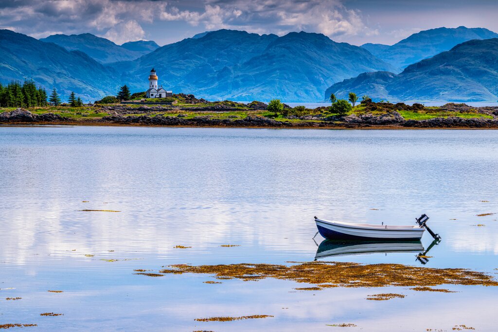 Views to the Isle Ornsay lighthouse from Skye—one of the six Scottish islands you'll visit on this trip